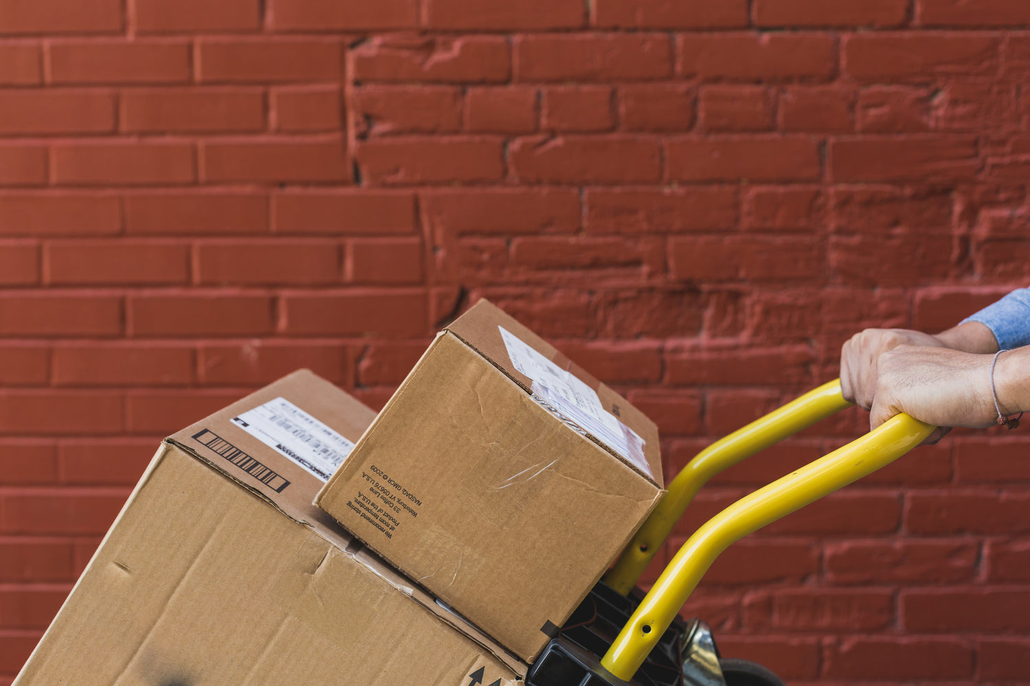 An image of two packages being moved to their destination via a trolley.